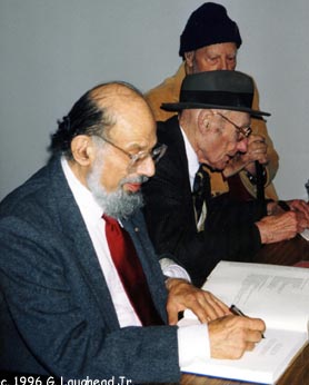 Allen Ginsberg and William S. Burroughs, photographed November 2, 1996, Spencer Museum of Art, KU, Lawrence, Kansas; Ports of Entry art exhibit. Their last public appearance together. George Kaull, Burroughs' friend, in background. Copyright 1996, George Laughead