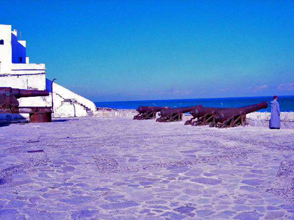 [Photograph:  Tangier beach with the big guns of ancient defenses. William Burroughs, Jack Kerouac, and Allen Ginsberg are in famous photograph in this area. Photograph copyright 2008 by C. Woww. Used with permission. All rights reserved.